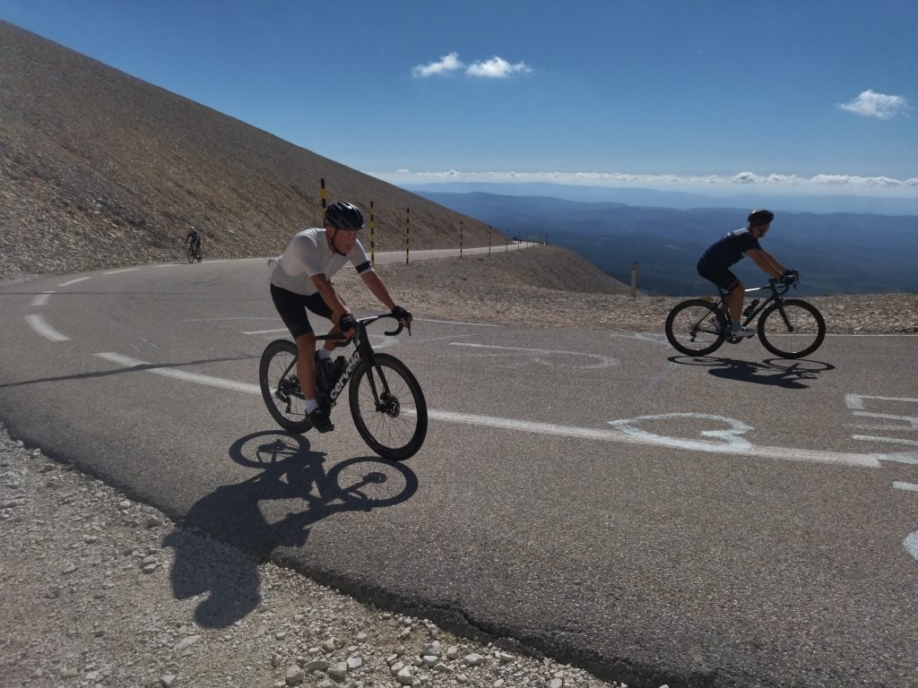 Two cyclists riding through the moonscape near the summit of Mont Ventoux
